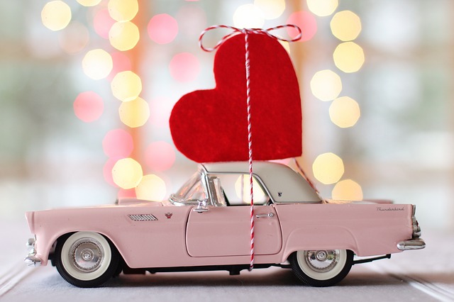 an image of a pink car with a large red heart on top of it